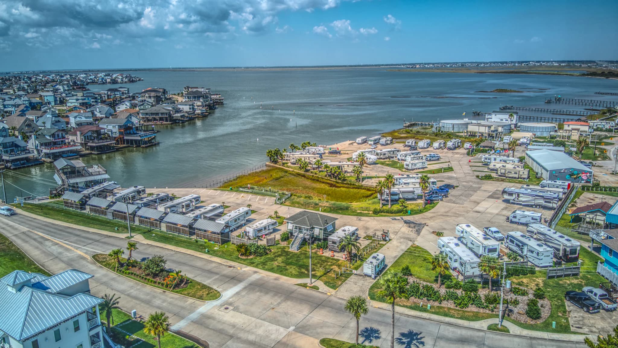 A current aerial view shows Tiki Tom’s RV sites, internal drives, shoreline, and surrounding water on Tiki Island.